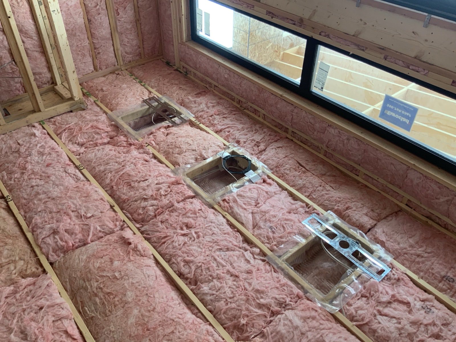 Insulation and framing photographed during a new construction inspection